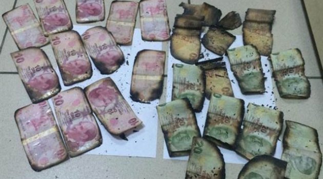 Polisi görünce paraları sobaya attı